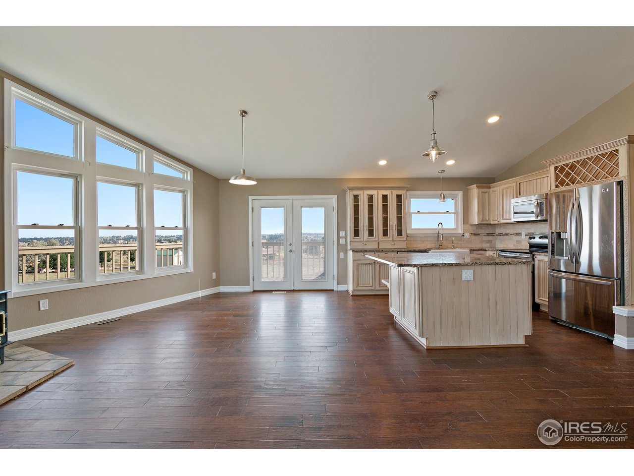 9088 North Awl Road Parker, CO 80138 - Photo 10 of 40 a view of kitchen with kitchen island wooden floor and refrigerator