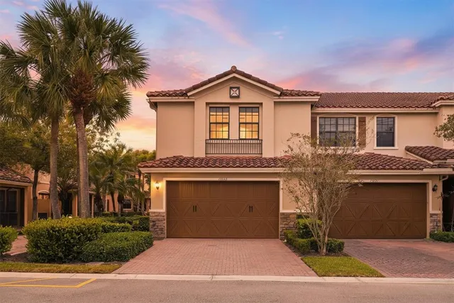 a front view of house with yard and trees around