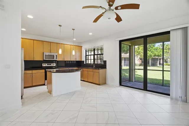 a kitchen with stainless steel appliances granite countertop a stove a sink and a refrigerator