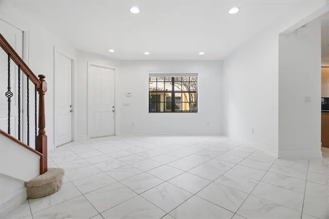 a view of an empty room and a window