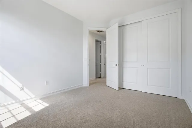 an empty room with closet area