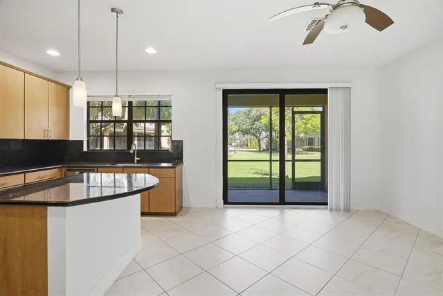 a kitchen with granite countertop a stove and a sink