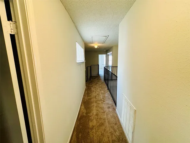 a view of a hallway with a white walls