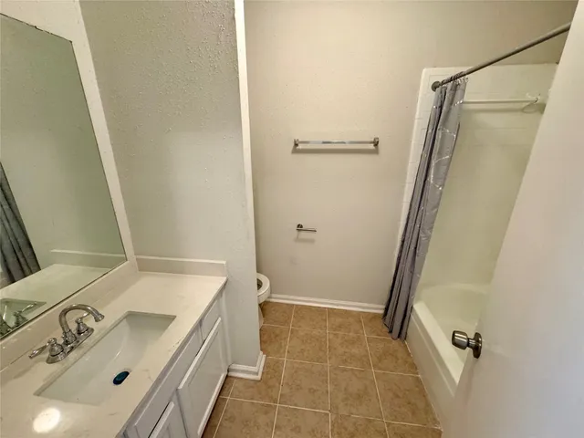 a bathroom with a sink a mirror and shower