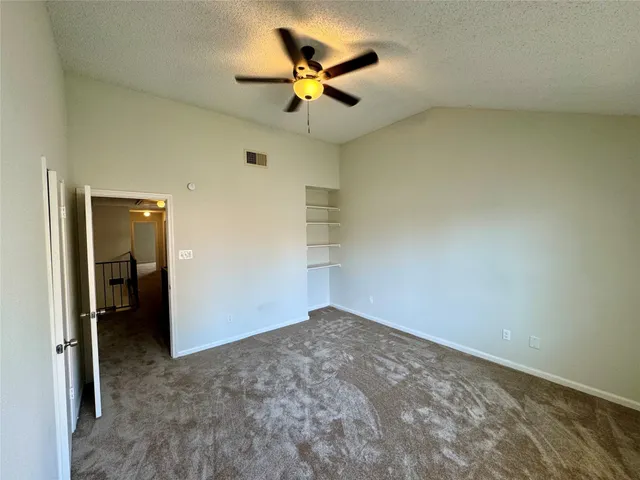 wooden floor in an empty room and a ceiling fan