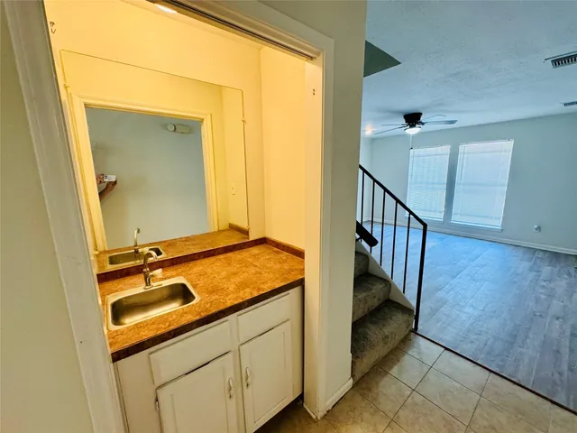 a bathroom with a granite countertop sink and a mirror