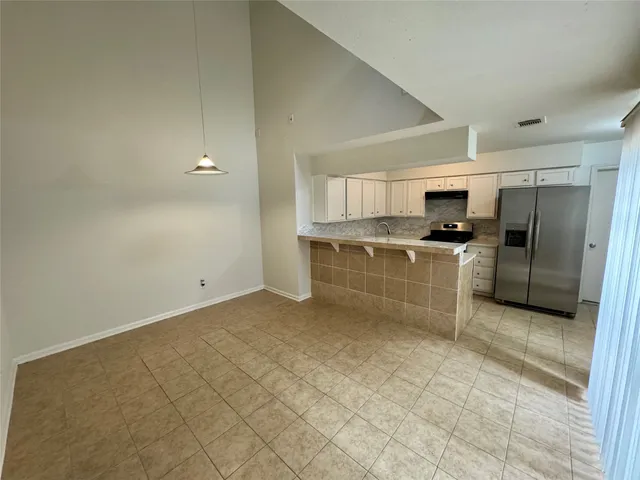 a large kitchen with cabinets and stainless steel appliances