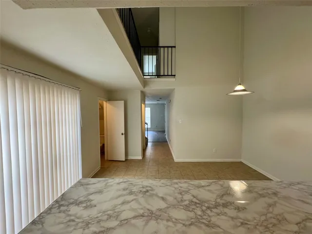 a view of an empty room with stairs