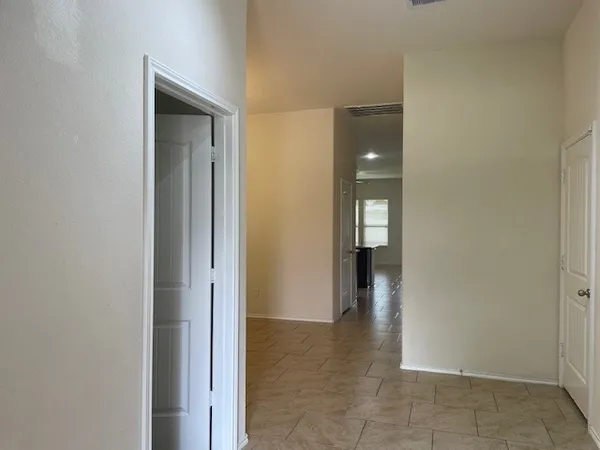 an empty room with a window and a ceiling fan