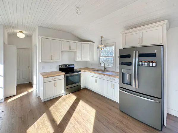 a kitchen with white cabinets and a sink