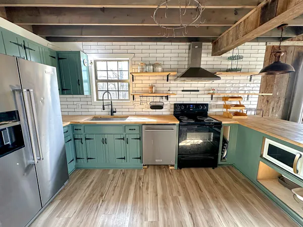 a kitchen with a sink a refrigerator and washer
