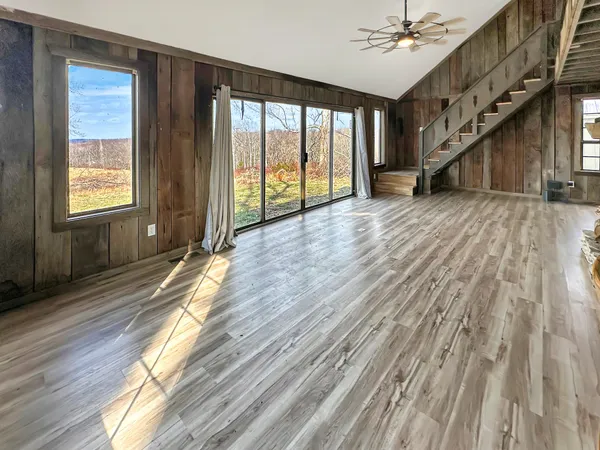 a view of entryway with stairs and wooden floor