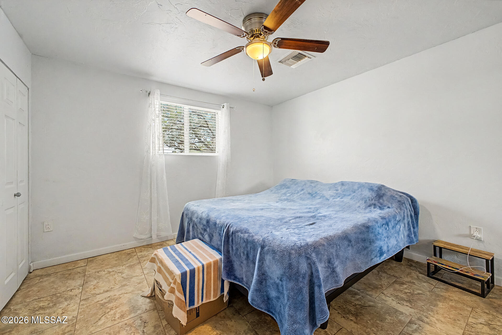 4231 East Pinal Street Tucson, AZ 85739 - Photo 32 of 36 a bedroom with a bed and a chandelier