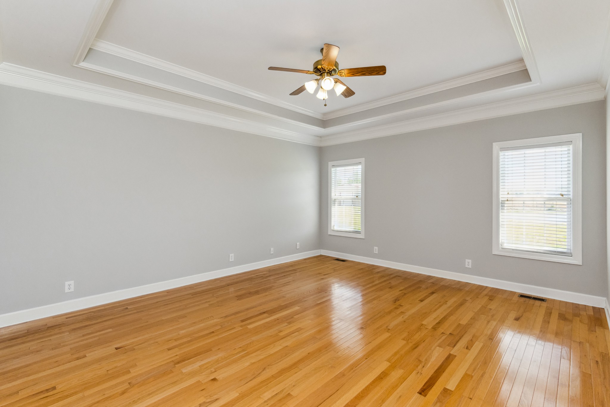 5592 Cedar Grove Road Murfreesboro, TN 37127 - Photo 43 of 43 The Primary Bedroom (#1) is on one side of this split floor plan with two large bedrooms on the other side! This room has windows to the back yard, a tray ceiling, ceiling fan, the lovely hardwood flooring and is 15'x17'!