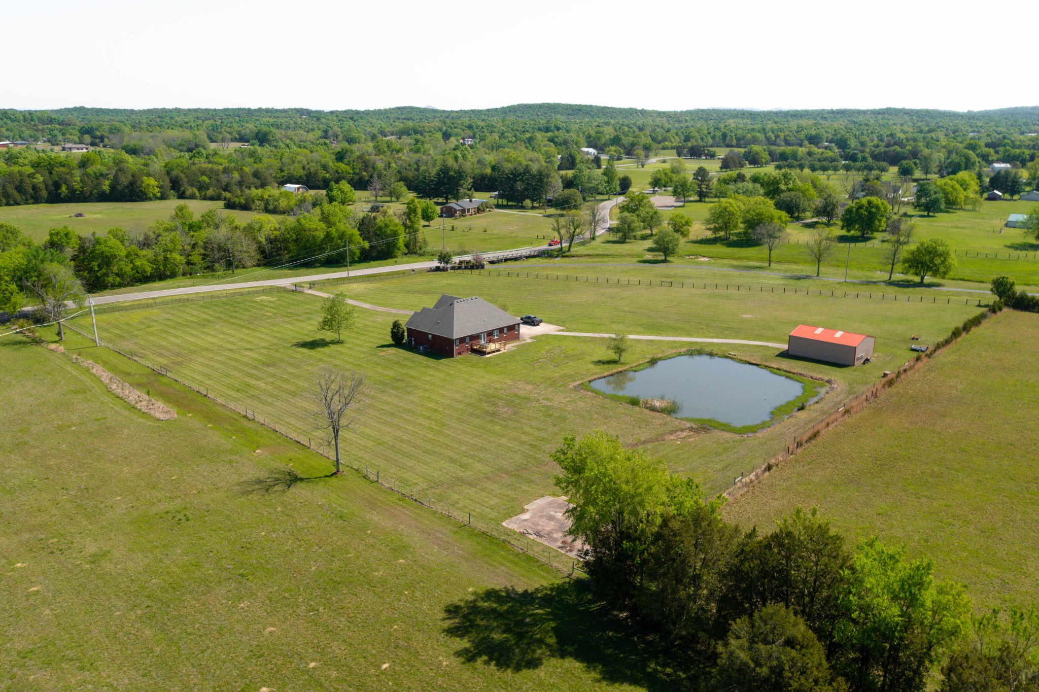 5592 Cedar Grove Road Murfreesboro, TN 37127 - Photo 36 of 43 This is a view from the back with the home, pond, detached shop/garage, and a concrete slab in the front corner from a previous outbuilding!