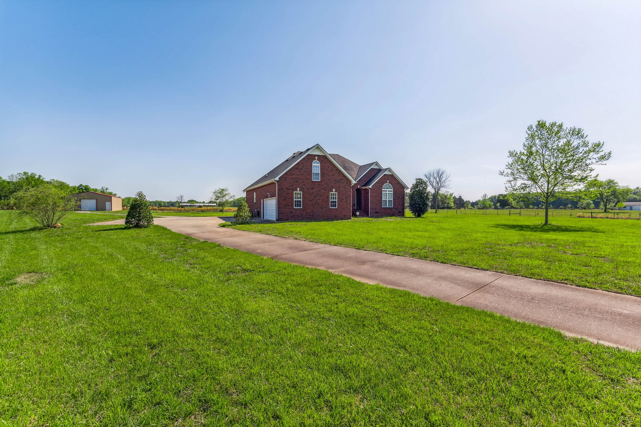 5592 Cedar Grove Road Murfreesboro, TN 37127 - Photo 5 of 43 From this view, you can see the concrete drive which goes up to a parking pad that can easily fit 4 vehicles, a 2-car attached garage, then on to the detached shop/garage, which can hold another two vehicles!