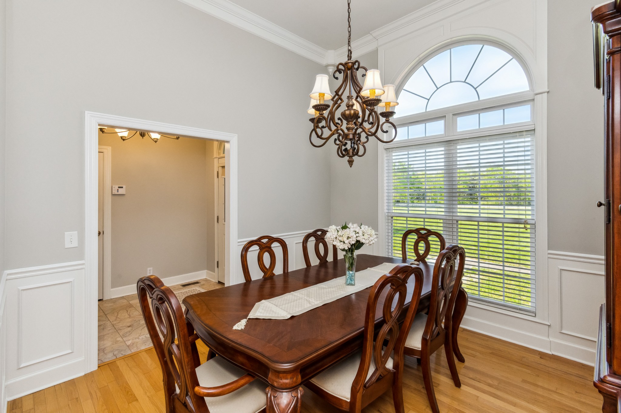 5592 Cedar Grove Road Murfreesboro, TN 37127 - Photo 8 of 43 The Dining Room is right off the entrance Foyer, with large chandalier and wainscotting trim along the walls. Blinds throughout the home remain!