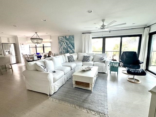 306 Pacifica Vista Way St. Augustine, FL 32080 - Photo 6 of 18 a living room with furniture a chandelier and a large window