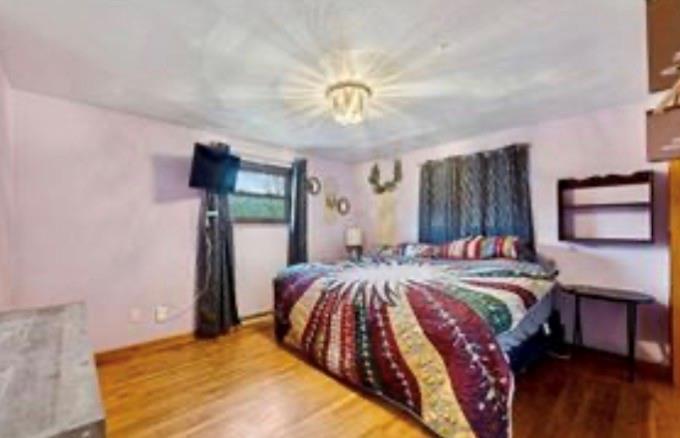 501 Highway 356 Apollo, PA 15613 - Photo 14 of 36 a bedroom with a bed and a chandelier
