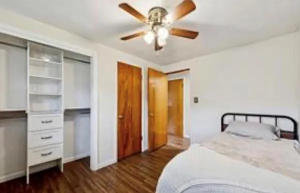 a bedroom with a bed and a chandelier
