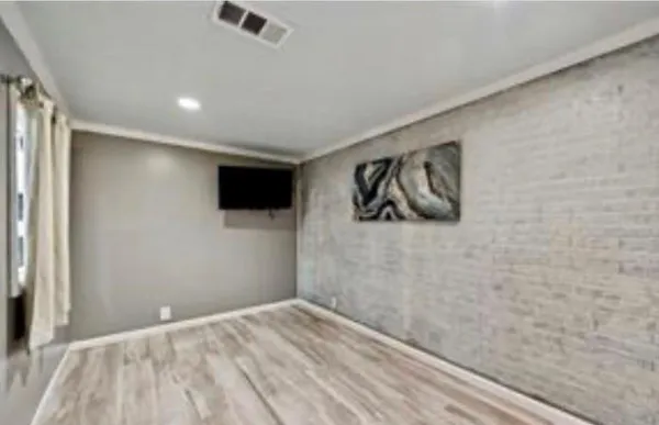 a view of a livingroom with wooden floor and a ceiling fan