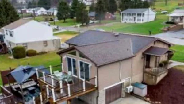 an aerial view of a house with garden space and street view