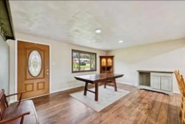 a view of a livingroom with furniture and a window