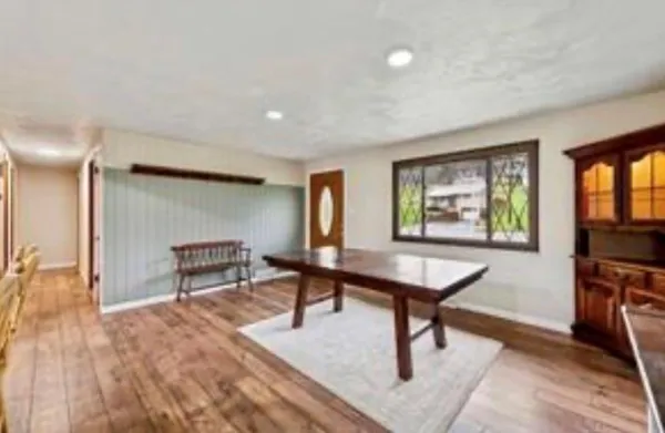 a room with furniture pool table and windows