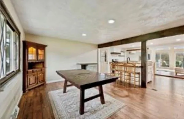 a view of a room with furniture and wooden floor