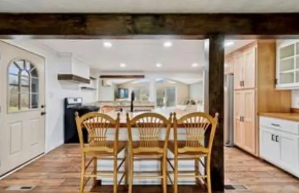 a view of a dining room with furniture and wooden floor