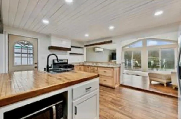 a kitchen with stainless steel appliances granite countertop a sink stove and cabinets