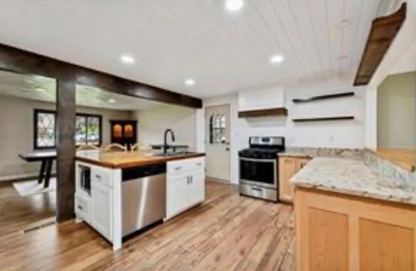 a kitchen with stainless steel appliances granite countertop a stove and a sink