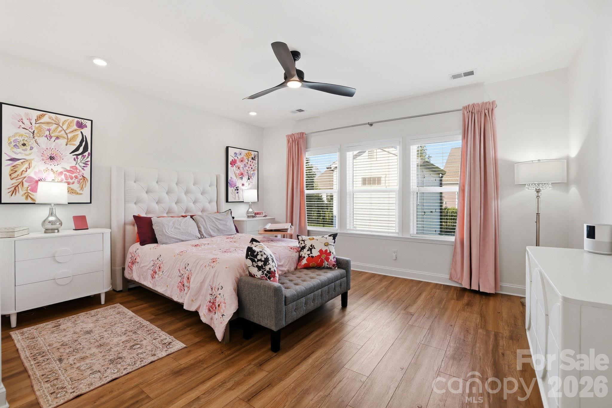 6038 Holland Street Fort Mill, SC 29707 - Photo 19 of 48 a spacious bedroom with a bed couch and a window