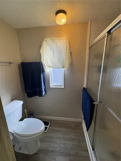 a bathroom with a toilet and a mirror
