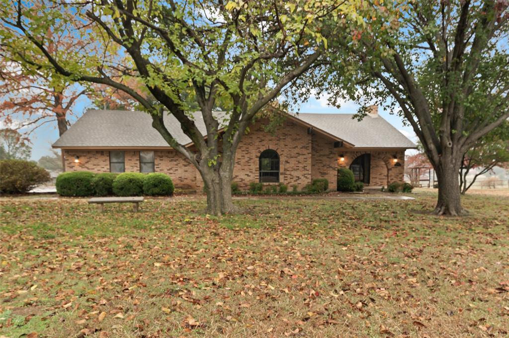 a white house that has a tree in front of it