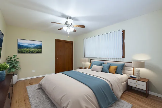 a bedroom with a large bed and a chandelier