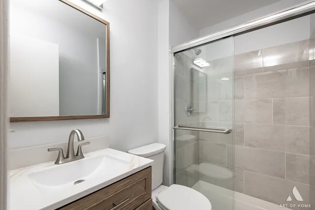 a bathroom with a sink toilet and shower