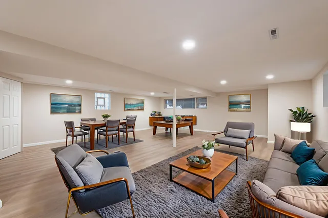a living room with furniture and wooden floor
