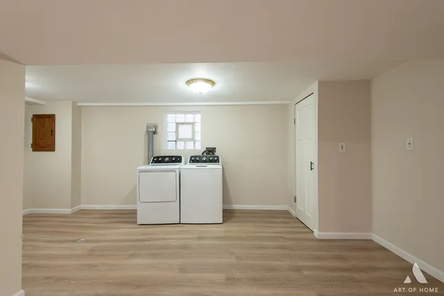 a view of a room with wooden floor and white walls