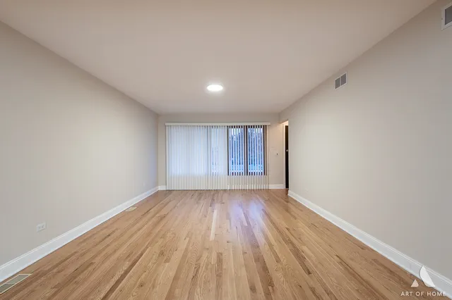 a view of an empty room and wooden floor