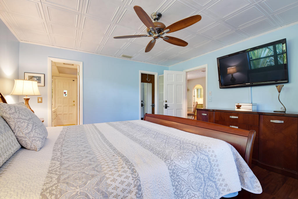 15429 Jupiter Farms Road Jupiter, FL 33478 - Photo 32 of 59 a bedroom with a bed and a flat screen tv