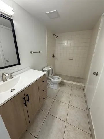 a bathroom with a sink a toilet a mirror and vanity