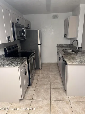 a kitchen with a stove top oven and sink