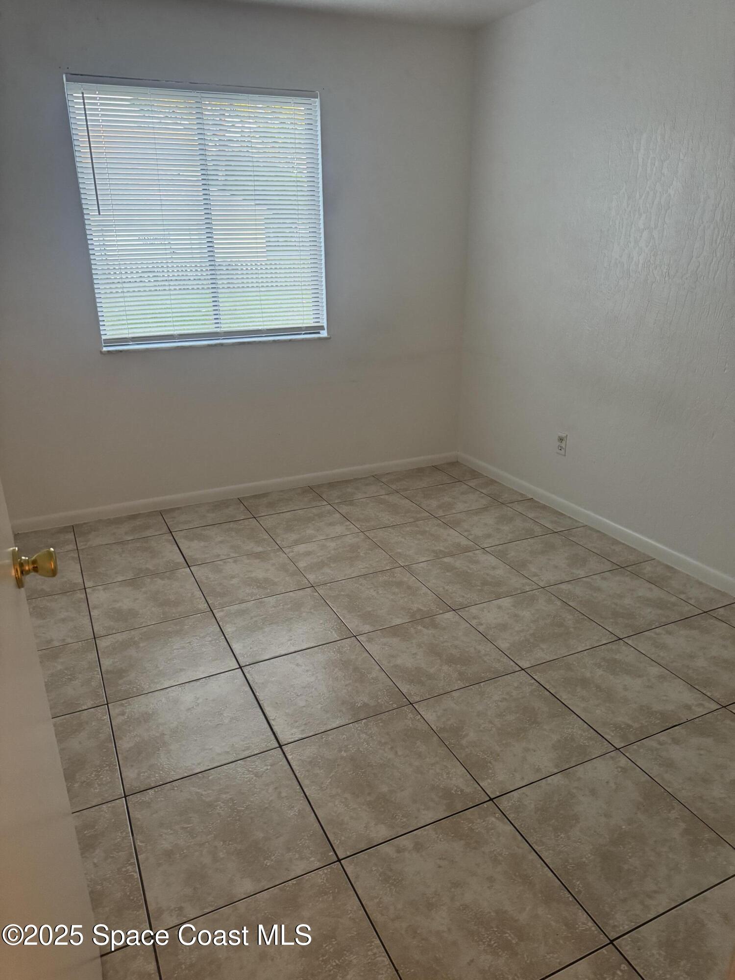 3212 Tree Ridge Lane Northeast Palm Bay, FL 32905 - Photo 6 of 8 a view of a room that has a window in it