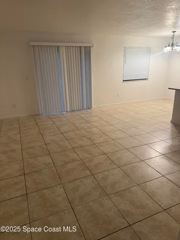 a view of an empty room and a window