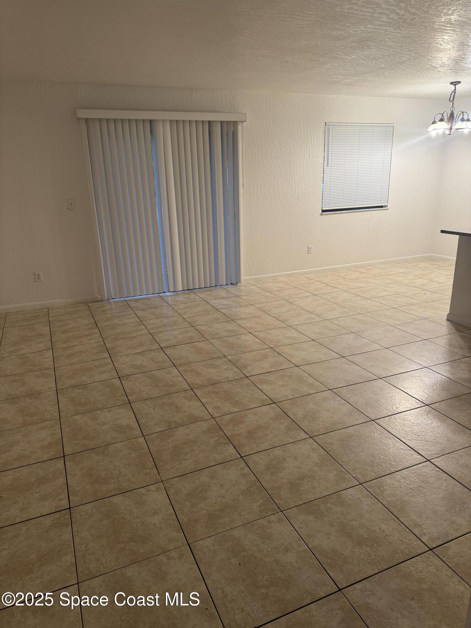 3212 Tree Ridge Lane Northeast Palm Bay, FL 32905 - Photo 7 of 8 a view of an empty room and a window