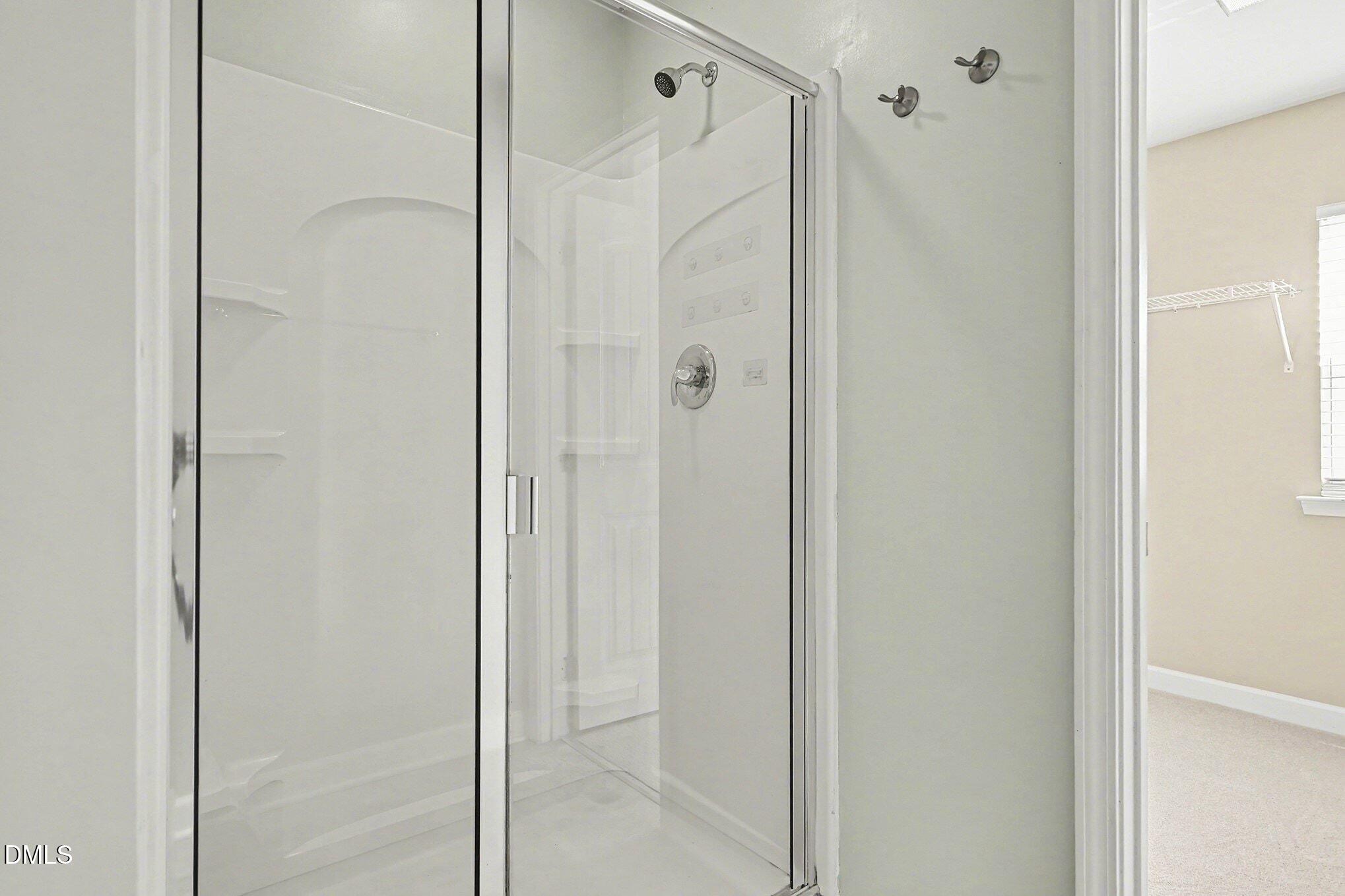 4818 Landover Bluff Way Raleigh, NC 27616 - Photo 20 of 30 a bathroom with a glass shower door