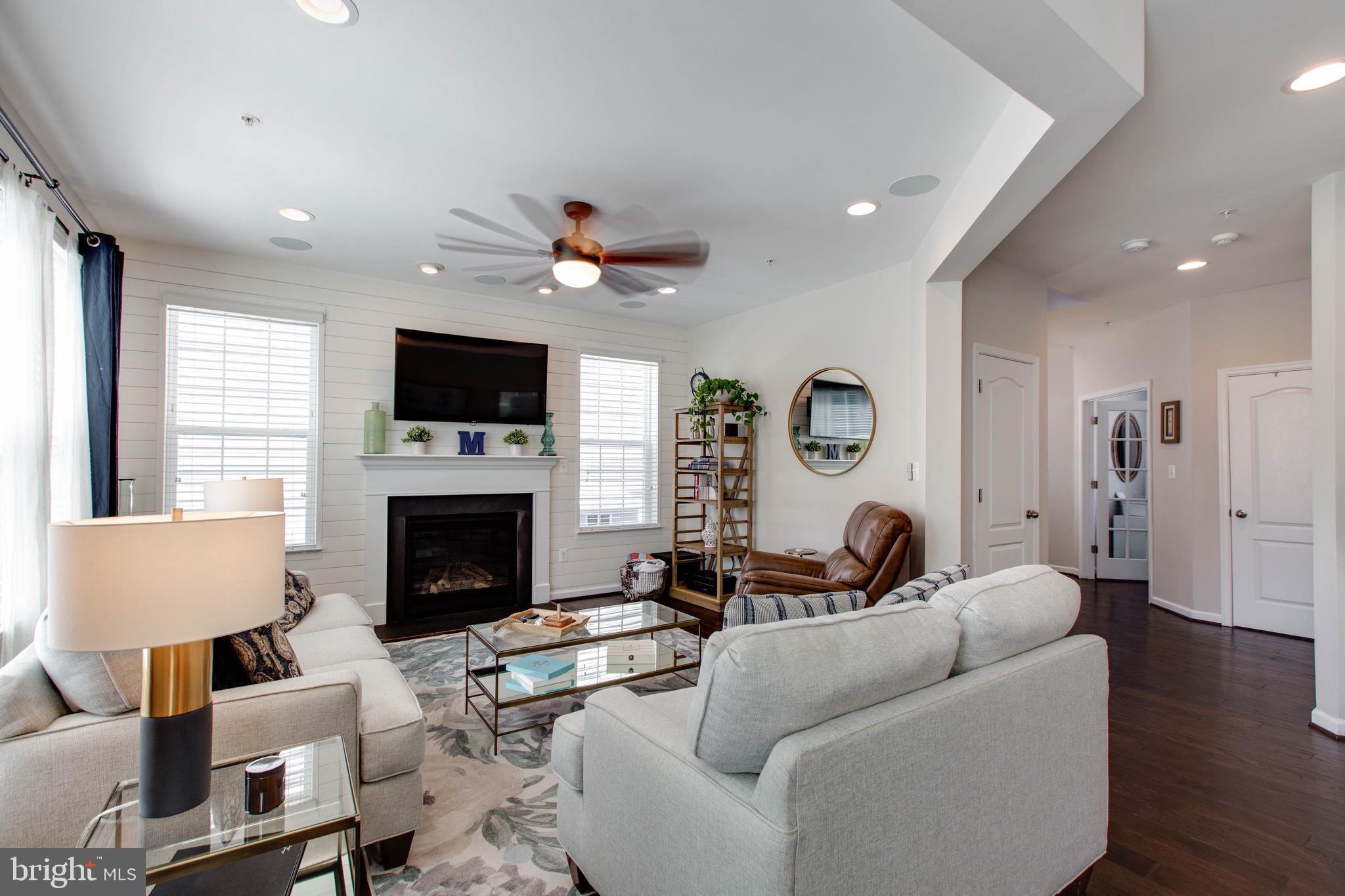 7870 Sunhaven Way Severn, MD 21144 - Photo 13 of 70 a living room with furniture a fireplace and a flat screen tv