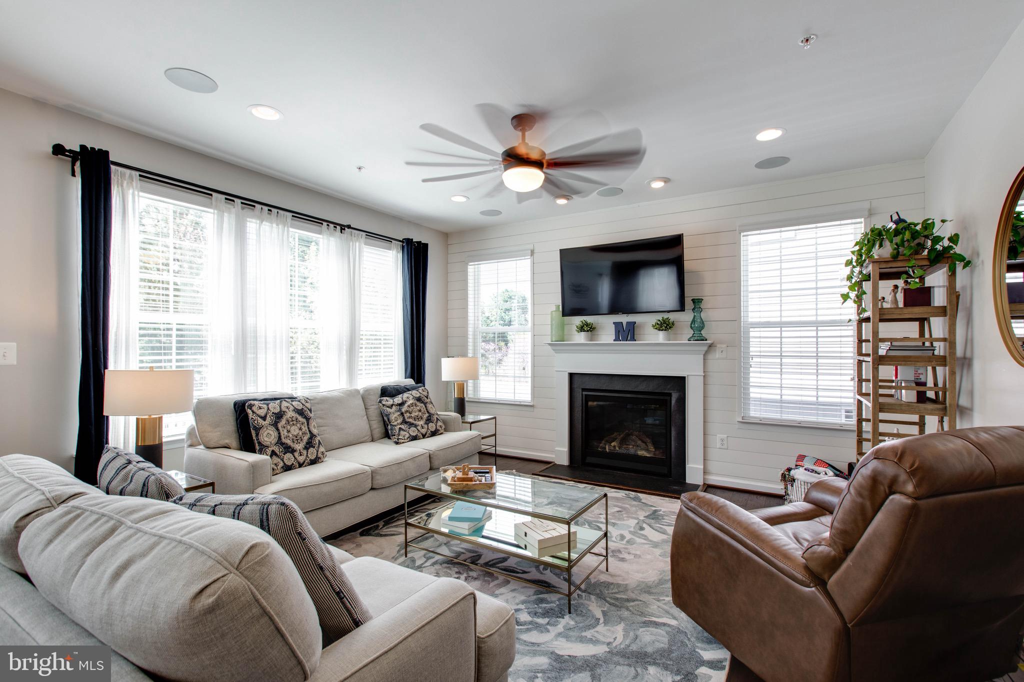 7870 Sunhaven Way Severn, MD 21144 - Photo 14 of 70 a living room with furniture a fireplace and a flat screen tv