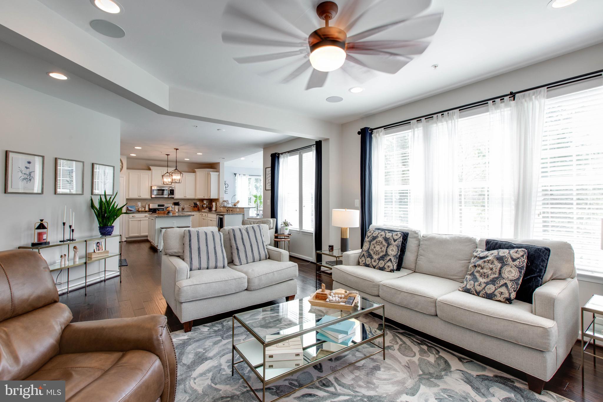 7870 Sunhaven Way Severn, MD 21144 - Photo 16 of 70 a living room with furniture ceiling fan and a large window